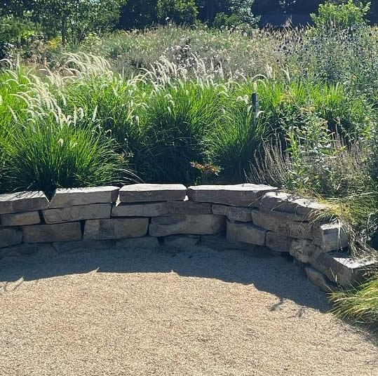 Photo of a boulder retaining wall built by White Oak Landscapes